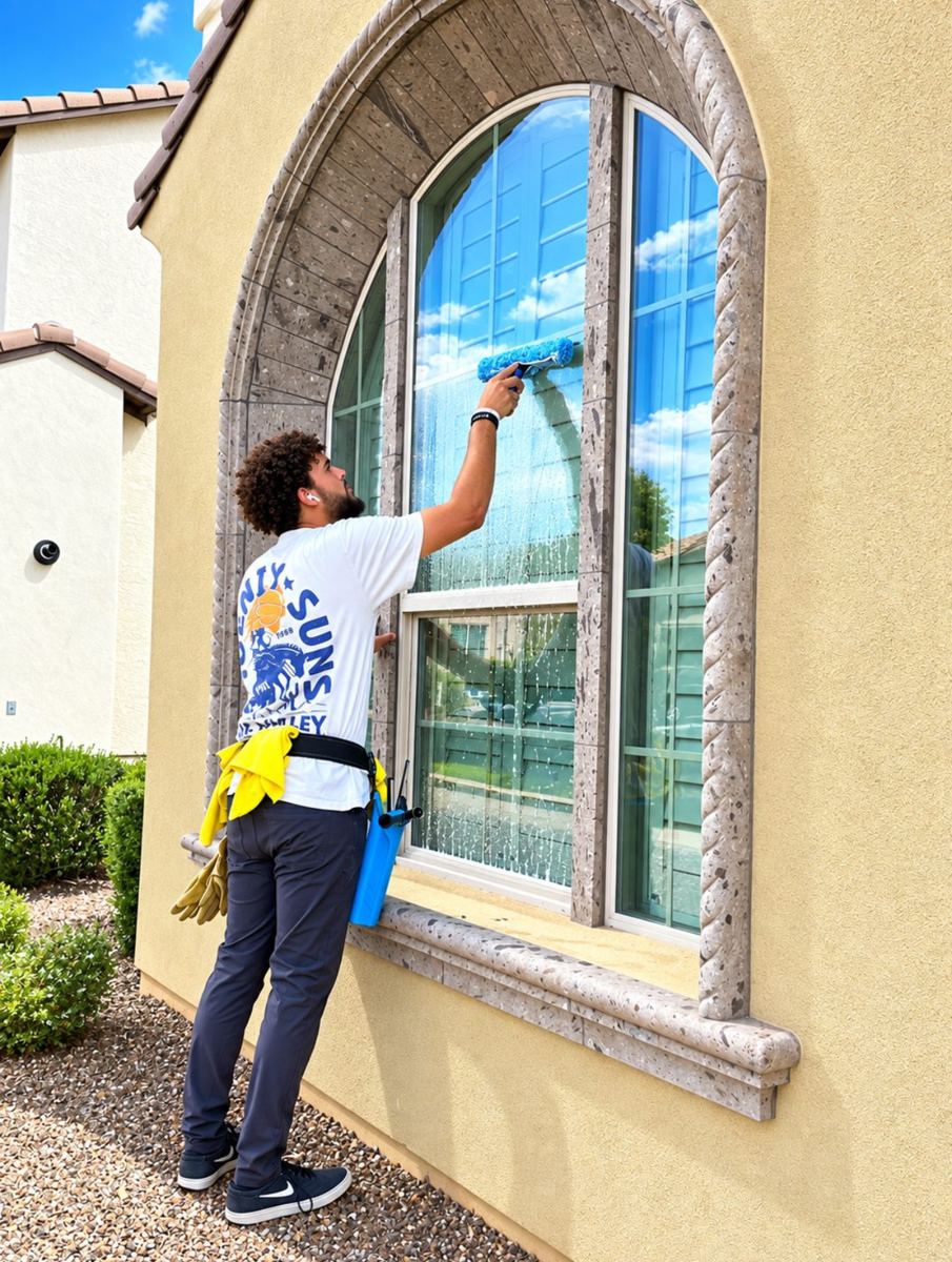 Cactus Valley technician cleaning a large arched window