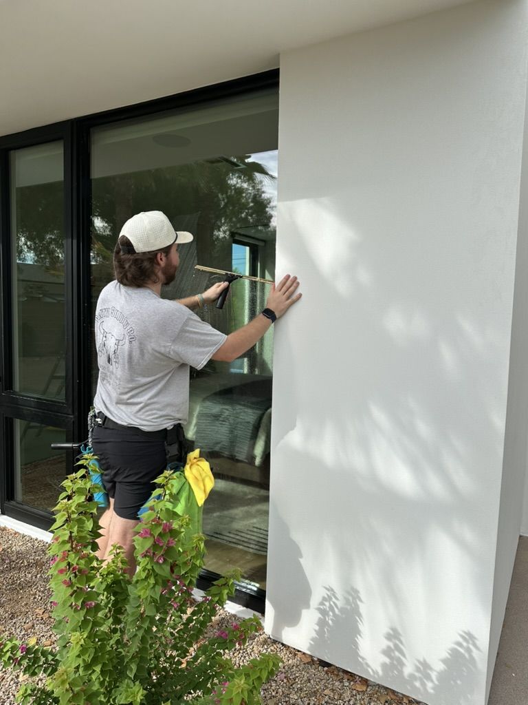 Tyler squeegeeing a sliding glass door
